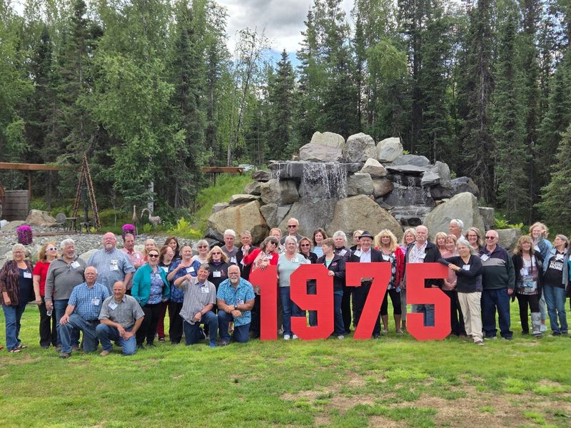 Class of 1975 reunion gathered in front of the waterfall