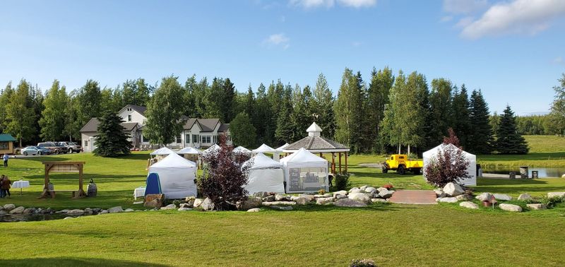 White event tents set up across the lawn