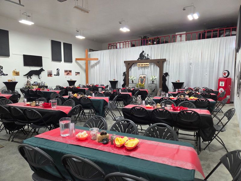 A western-themed indoor dinner with red table runners