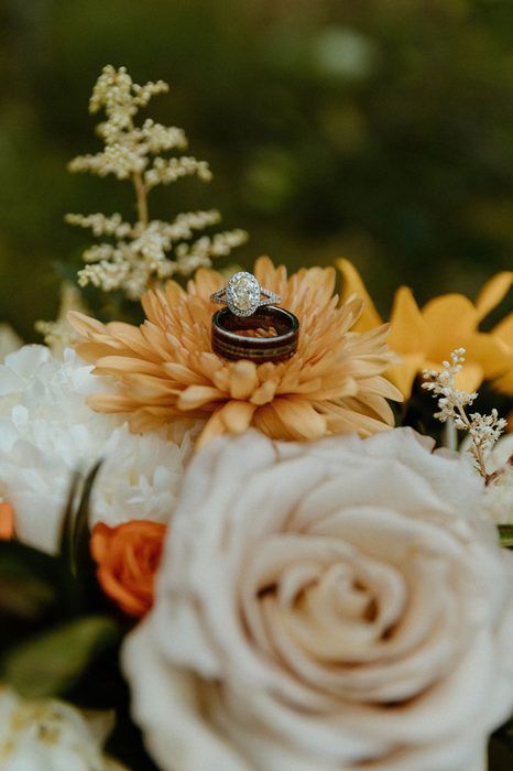 A wedding ring resting on a flower bouquet